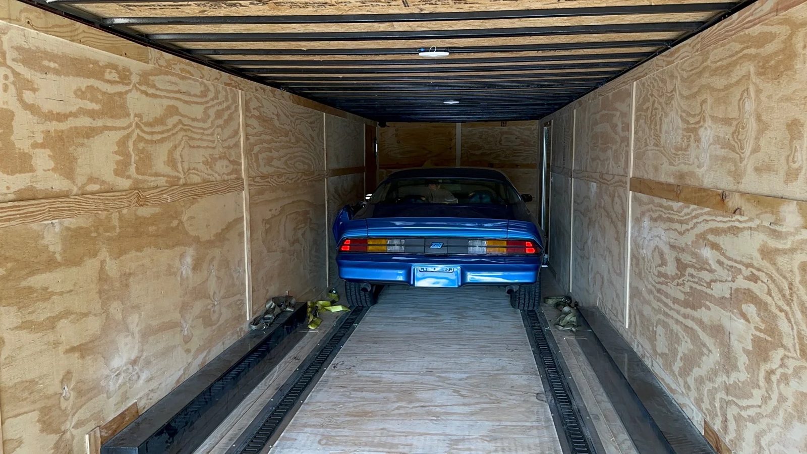Classic car inside an enclosed trailer