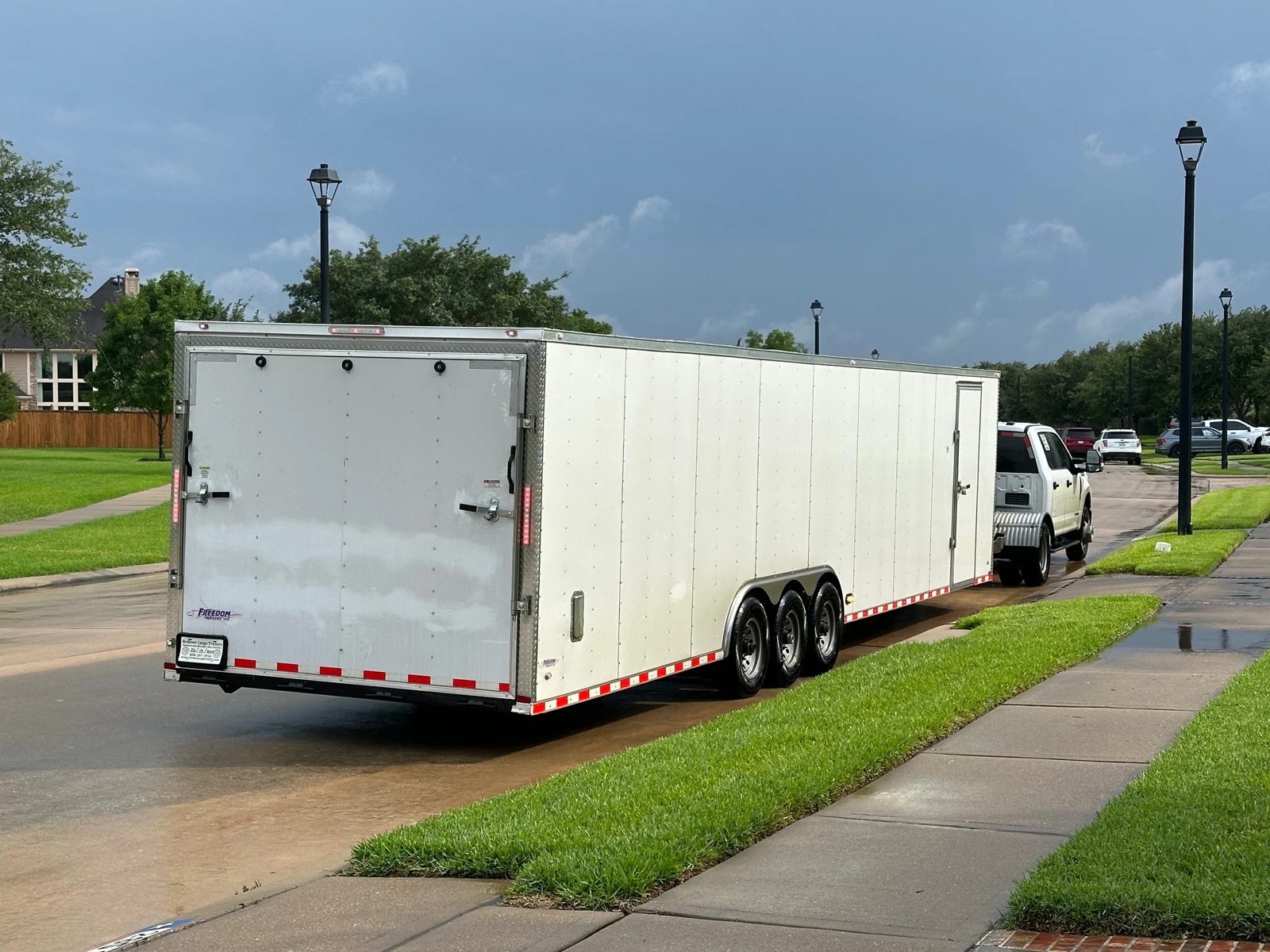 An enclosed trailer parked in a buyer's driveway